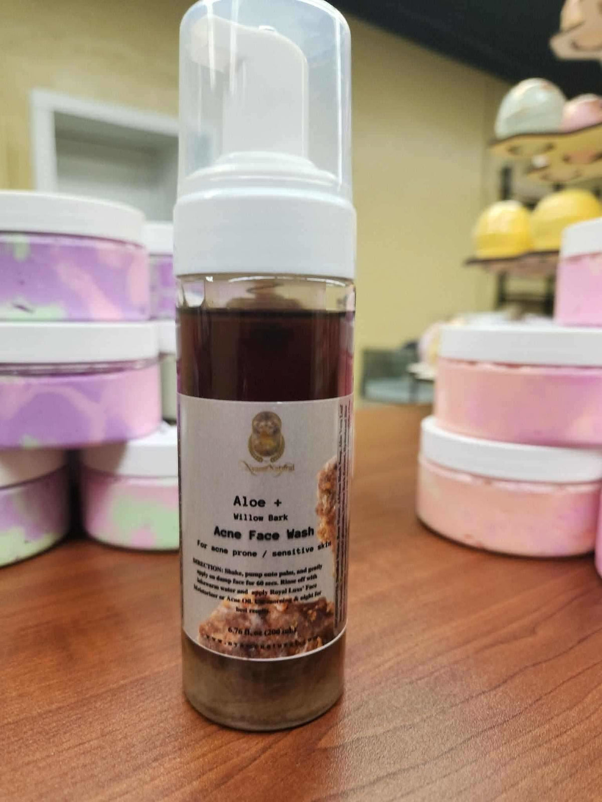 RoyalLuxsLLC aloe willow bark acne face wash bottle with pump dispenser on wooden surface