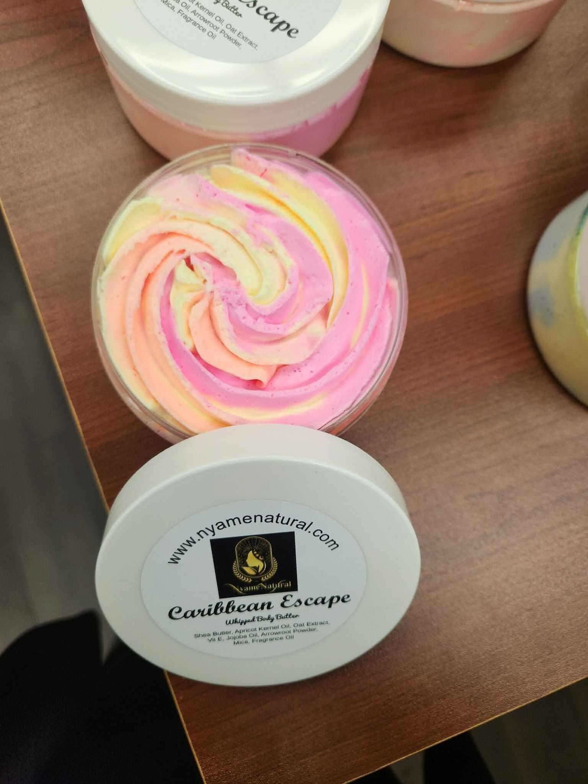 RoyalLuxsLLC Caribbean Escape body butter in a jar with pink and yellow swirled cream