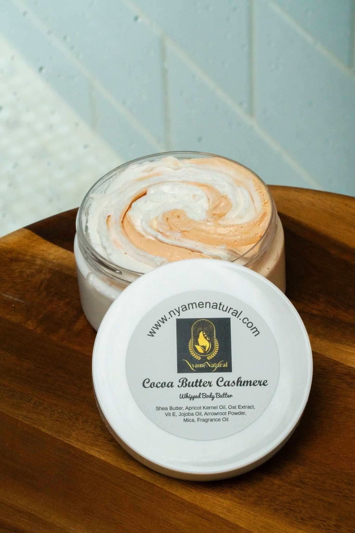 RoyalLuxsLLC cocoa butter cashmere body butter in open jar showing creamy swirl texture on wooden surface