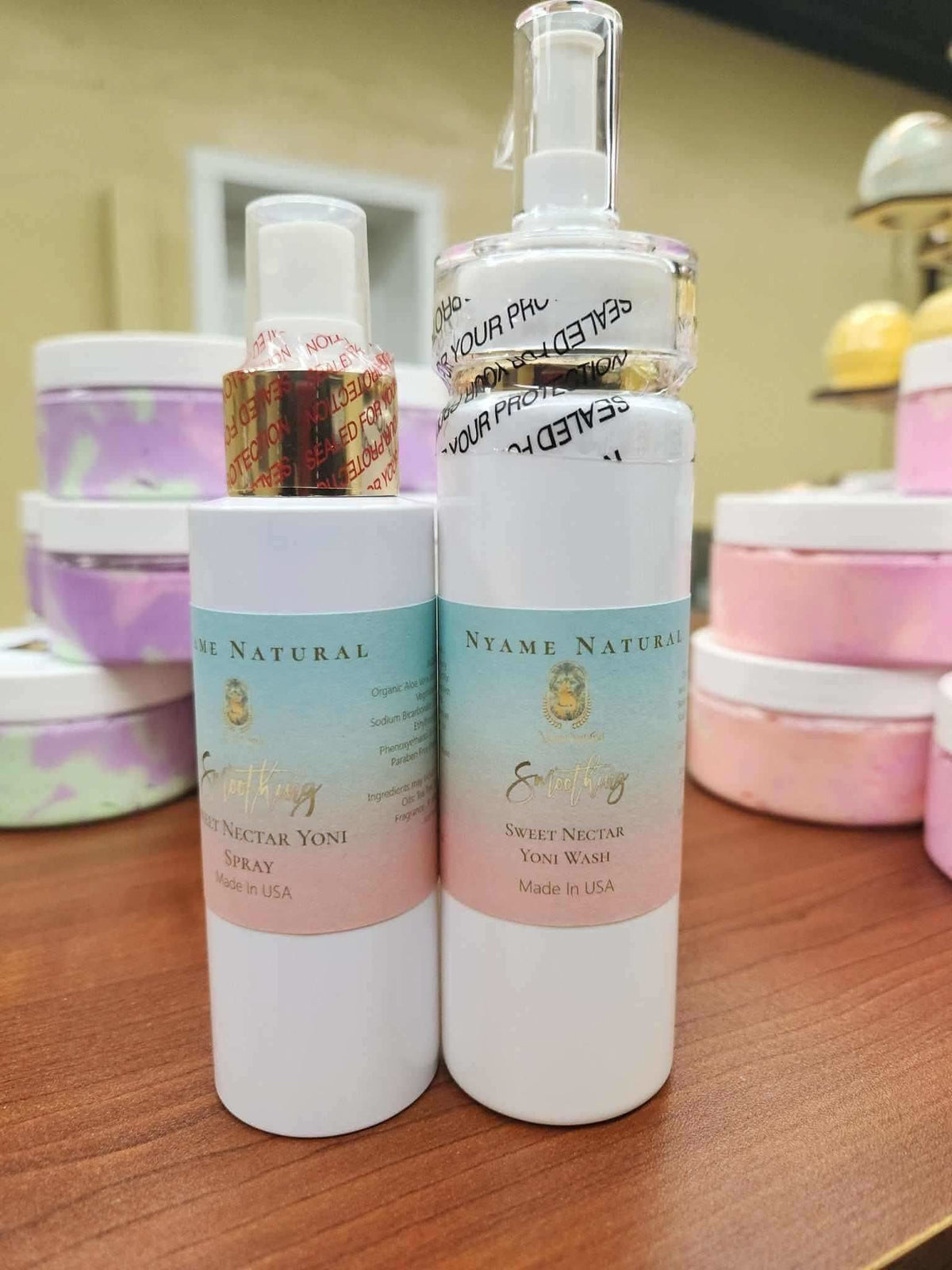 Herbal yoni wash and spray kit by RoyalLuxsLLC with white bottles and pastel labels on wooden surface