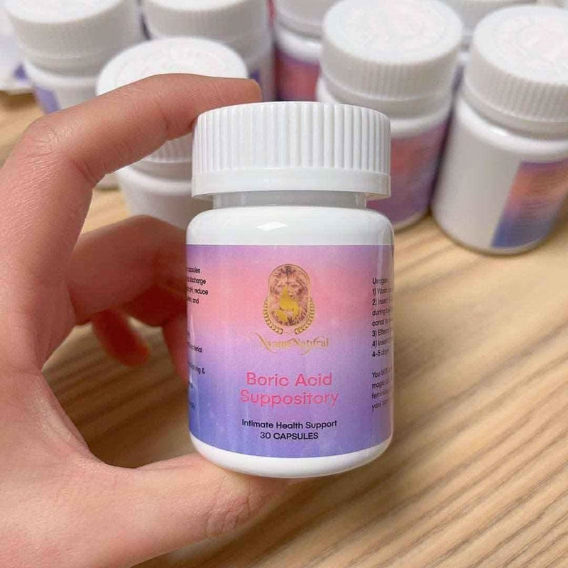 Pure Boric Acid suppository bottle in hand for intimate health support, 30 capsules for detox and cleanse.