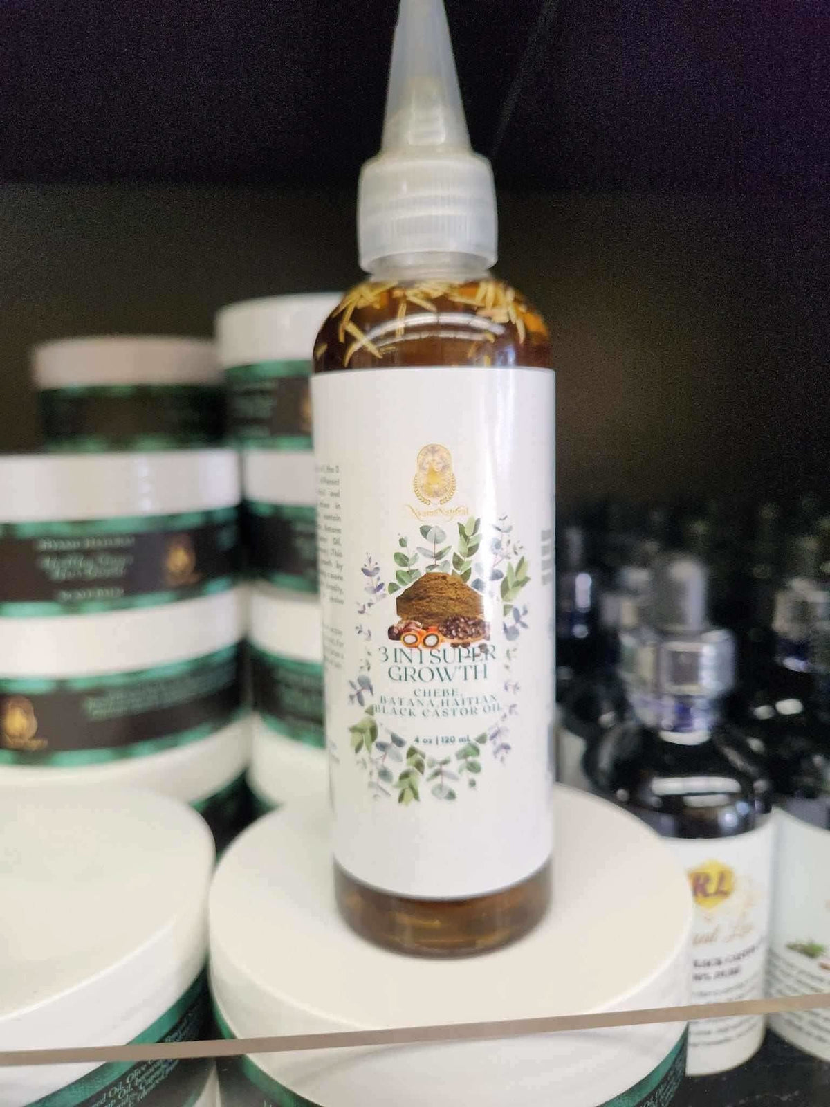 RoyalLuxsLLC 3 in 1 hair growth oil bottle with herbal ingredients on store shelf