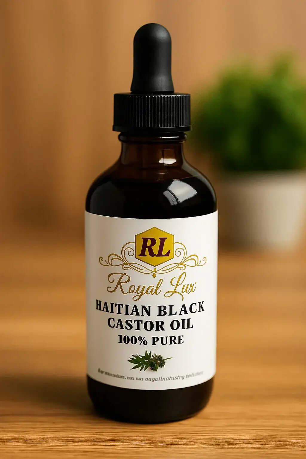 RoyalLuxsLLC bottle of 100% pure Haitian black castor oil with dropper on wooden surface