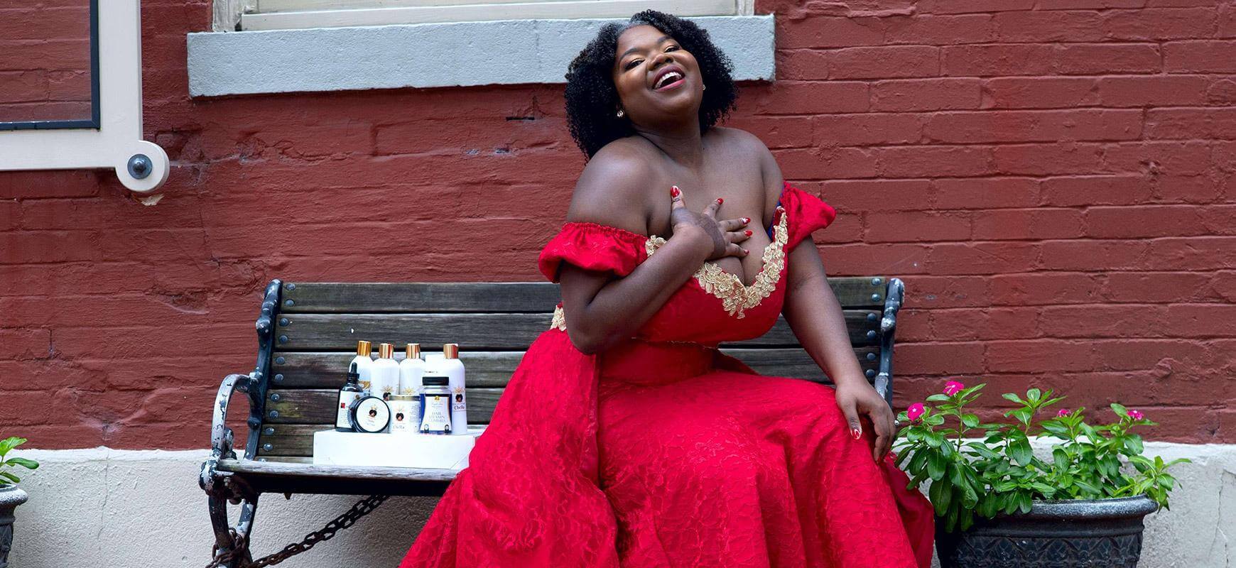 Smiling woman in a red dress showcasing best sellers like shampoos and hair growth products on a bench.
