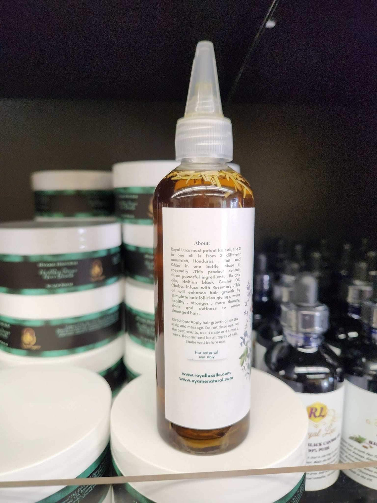 3 in 1 Supergrowth Batana Chebe Haitian Black Castor Oil bottle on display, promoting thicker, fuller hair.
