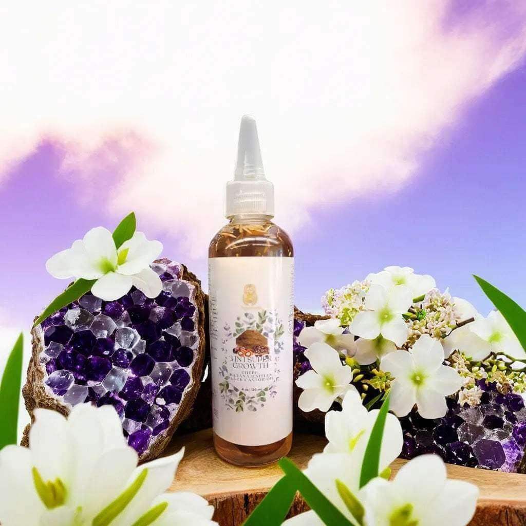 3 in 1 Supergrowth Batana Chebe Haitian Black Castor Oil surrounded by flowers and crystals for healthy hair.