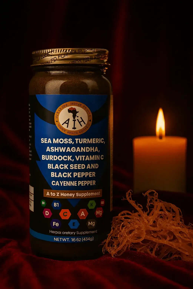 Herbal honey with sea moss and turmeric supplement bottle by RoyalLuxsLLC with a lit candle and sea moss on red fabric
