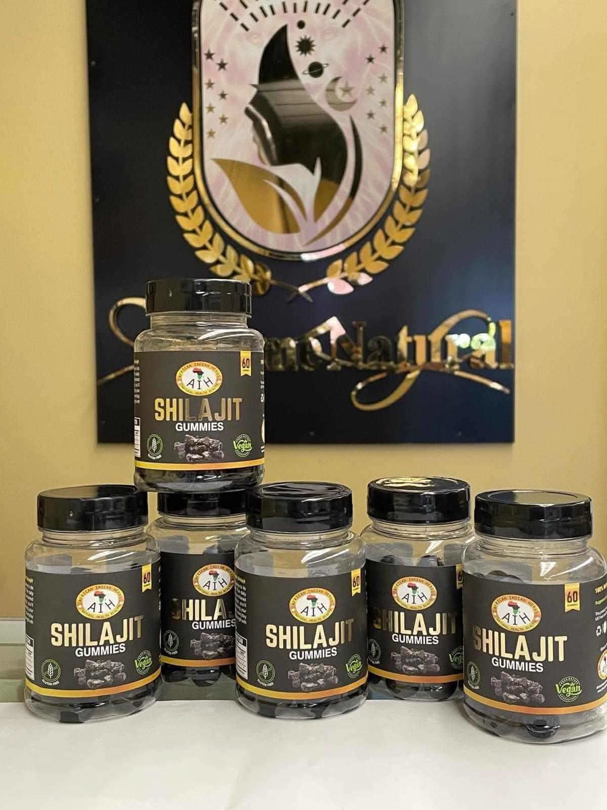 RoyalLuxsLLC Shilajit gummies bottles arranged in front of decorative background with black and gold design