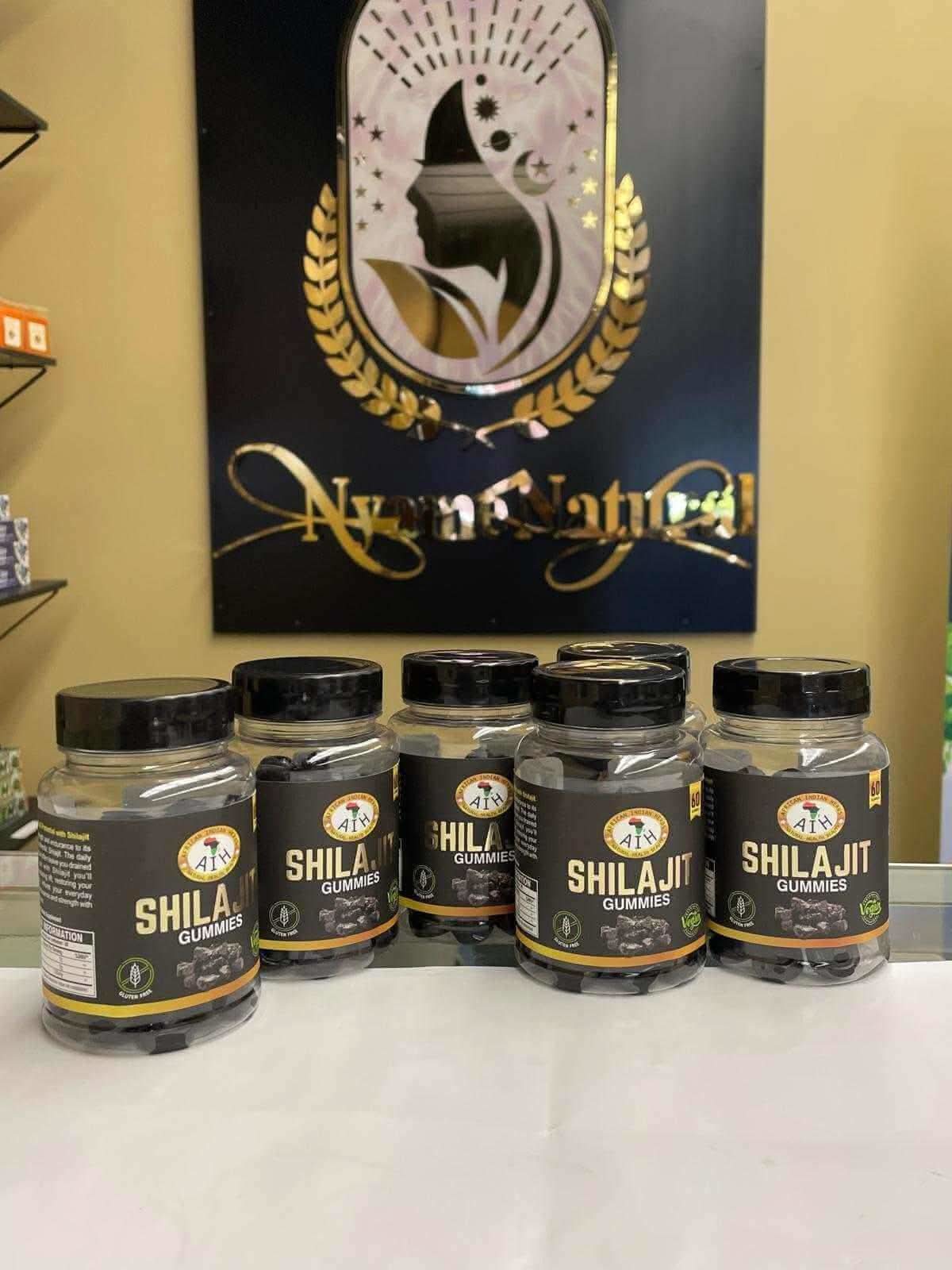 Five bottles of RoyalLuxsLLC Shilajit gummies with black and gold labels on white surface