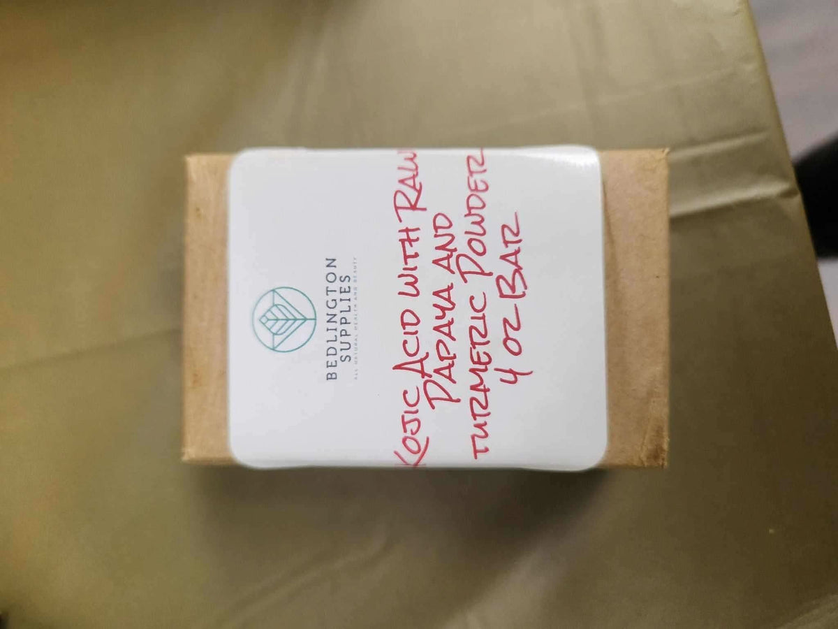 RoyalLuxsLLC kojic acid turmeric soap bar wrapped in simple brown paper packaging