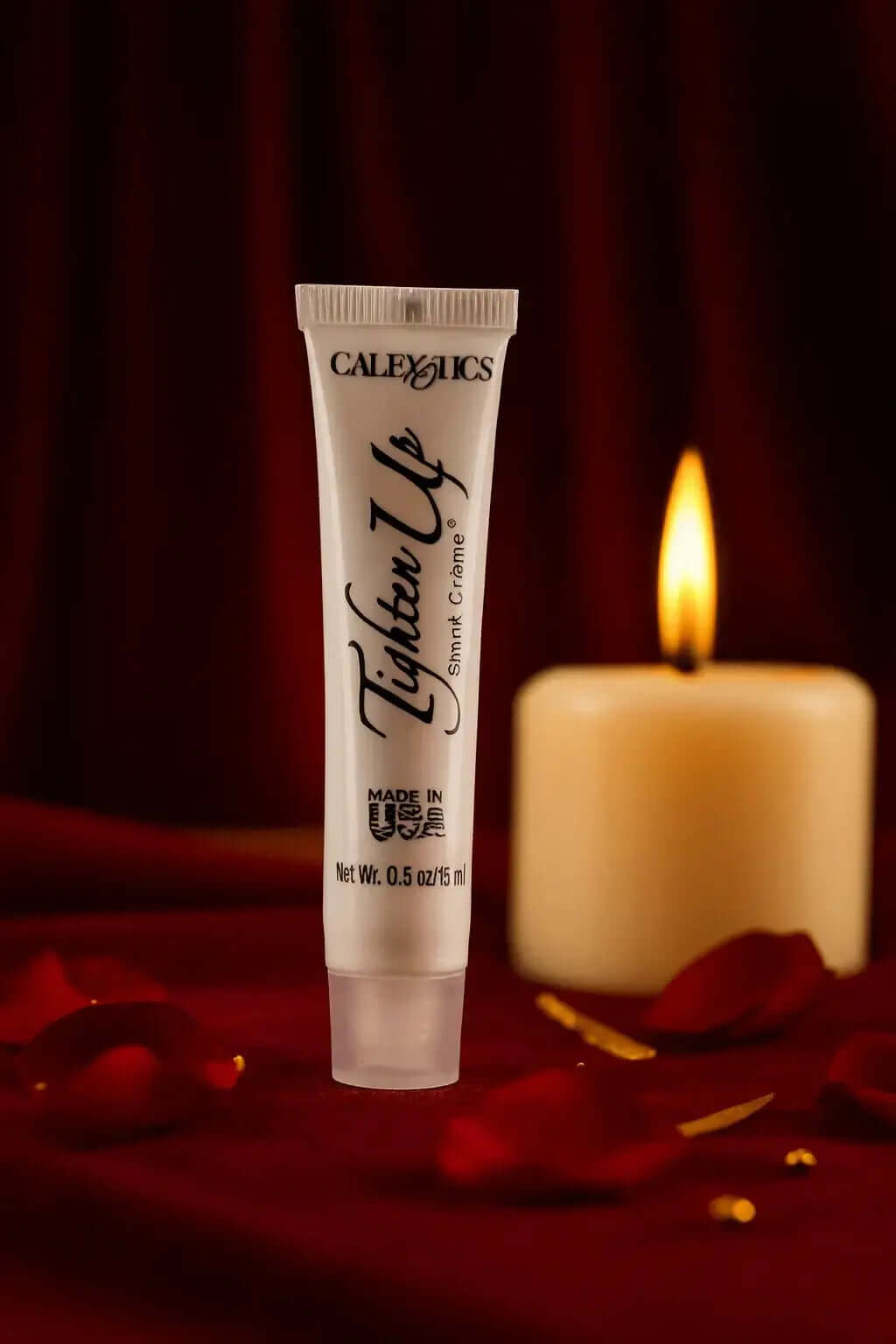 CalExotics Tighten Up vaginal tightening cream tube with candle and rose petals background