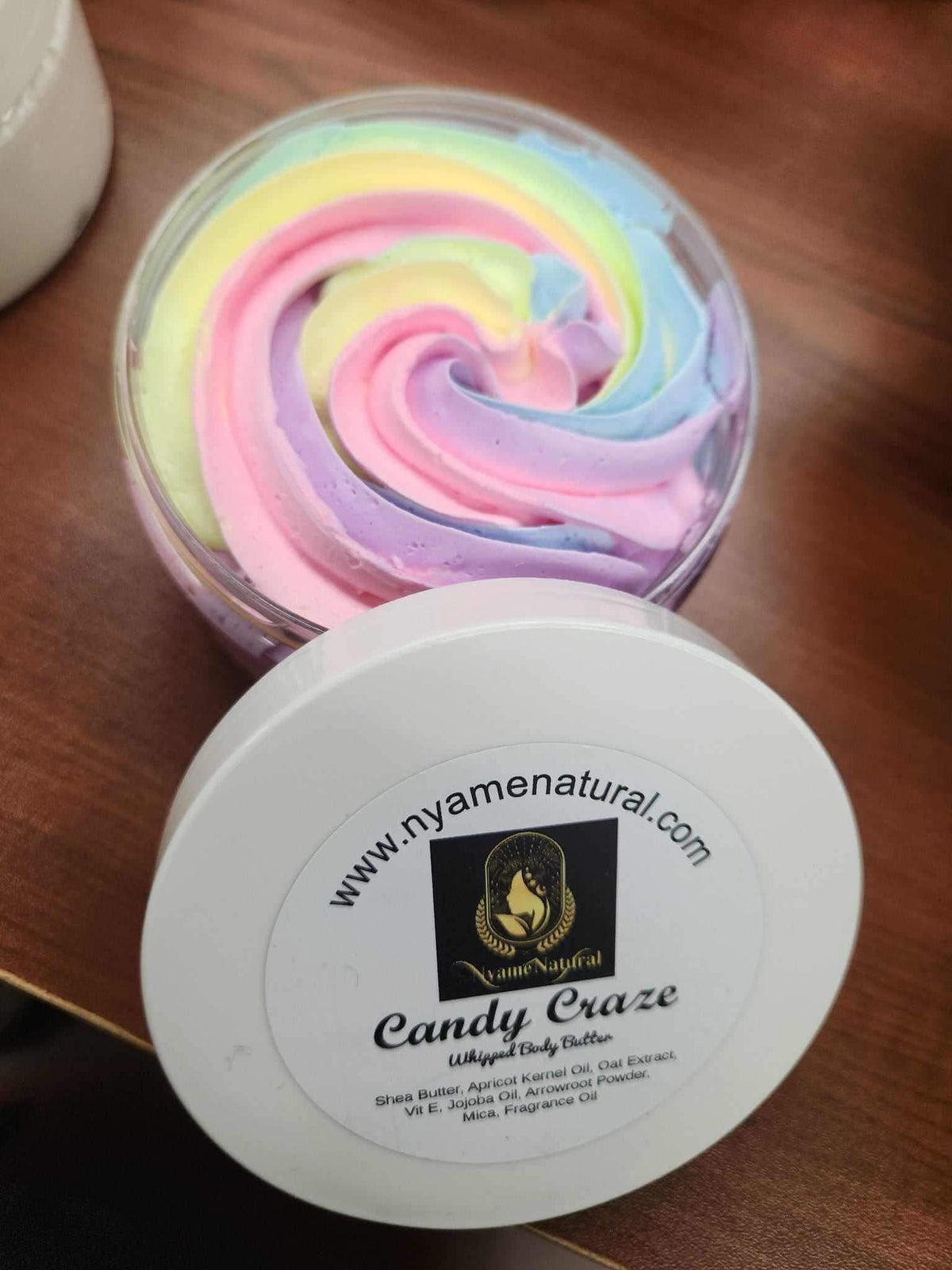 Candy Craze Body butter in a colorful swirl, offering luxurious hydration and a delightful fragrance.