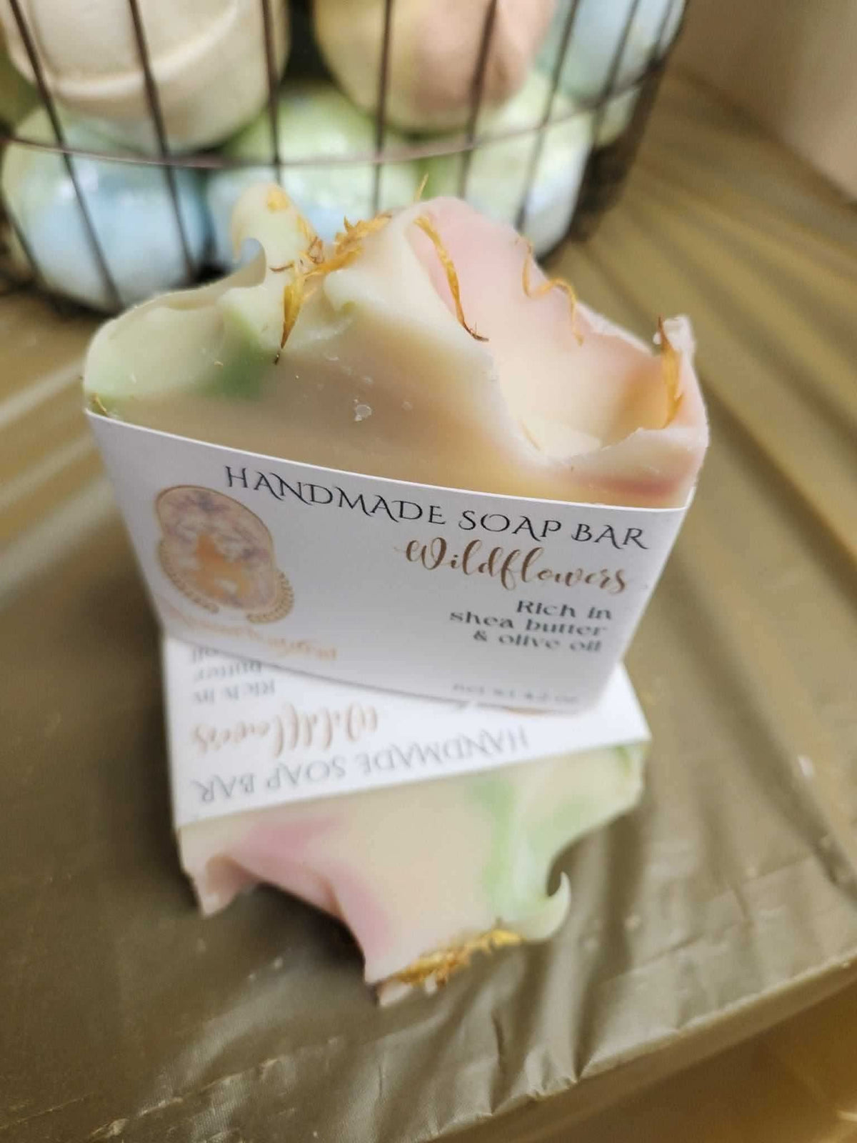 RoyalLuxsLLC handmade wildflowers soap bar with natural colors and floral accents on wooden surface