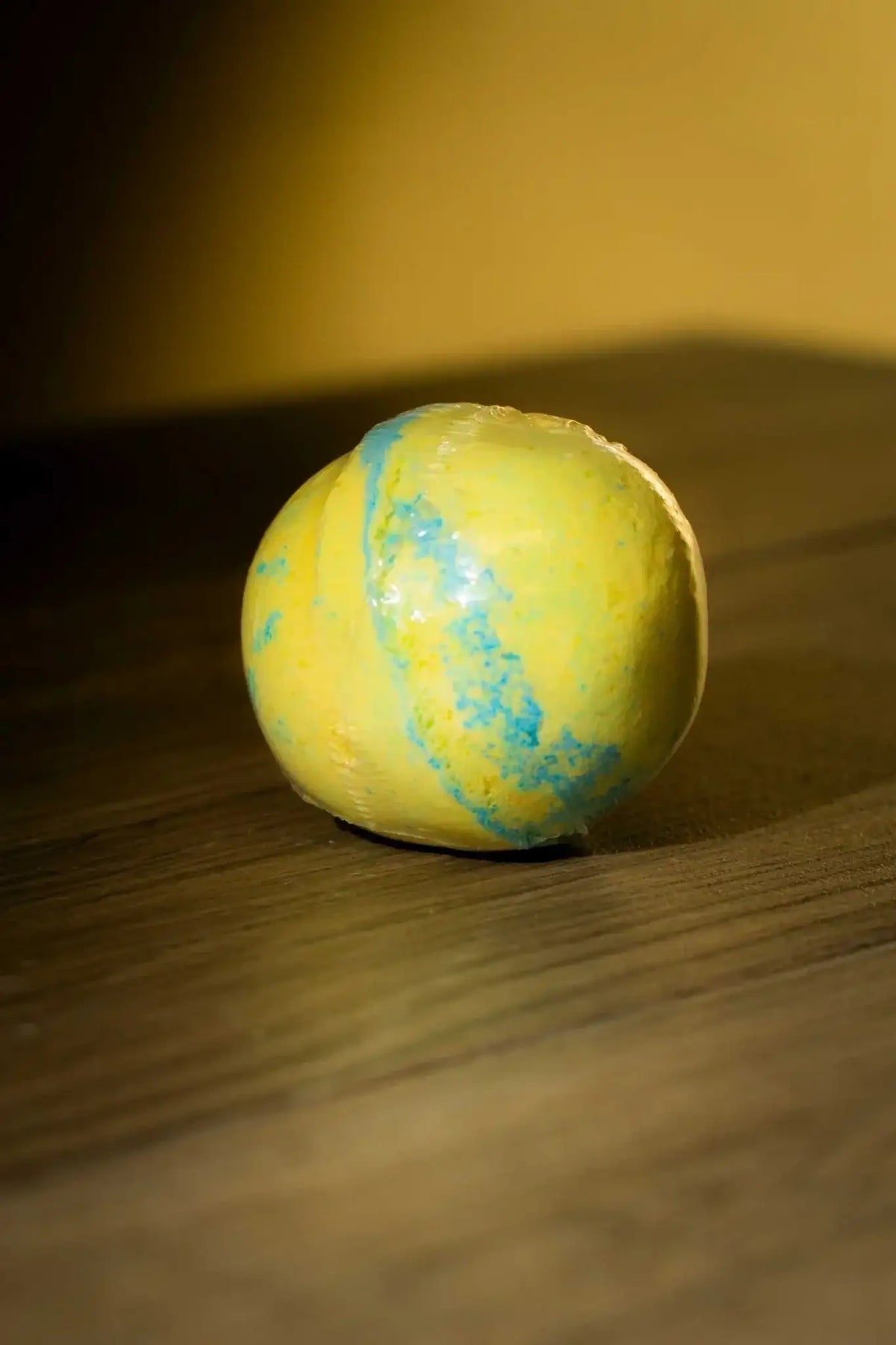 Luxurious Body Bath Bomb in vibrant yellow and blue, perfect for detox and cleanse rituals.