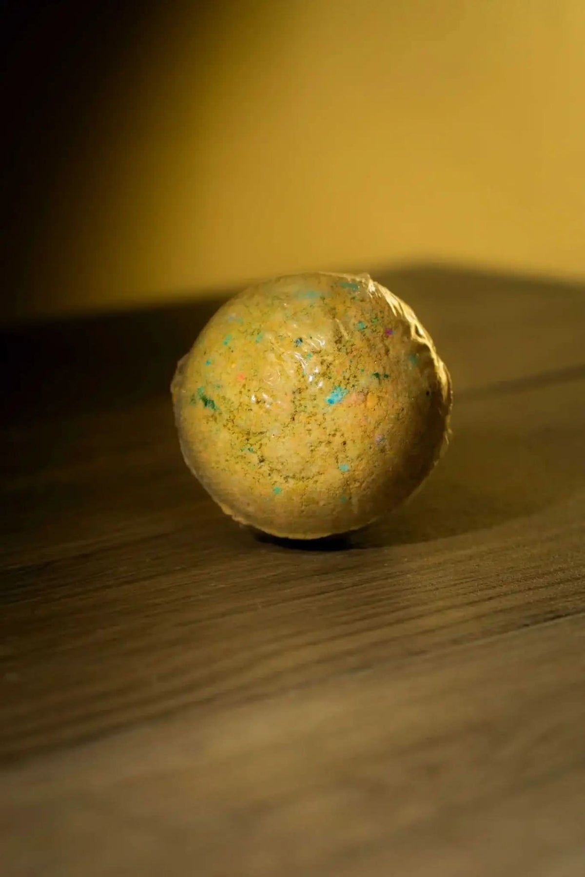 RoyalLuxsLLC luxurious herbal bath bomb with natural ingredients placed on wooden surface