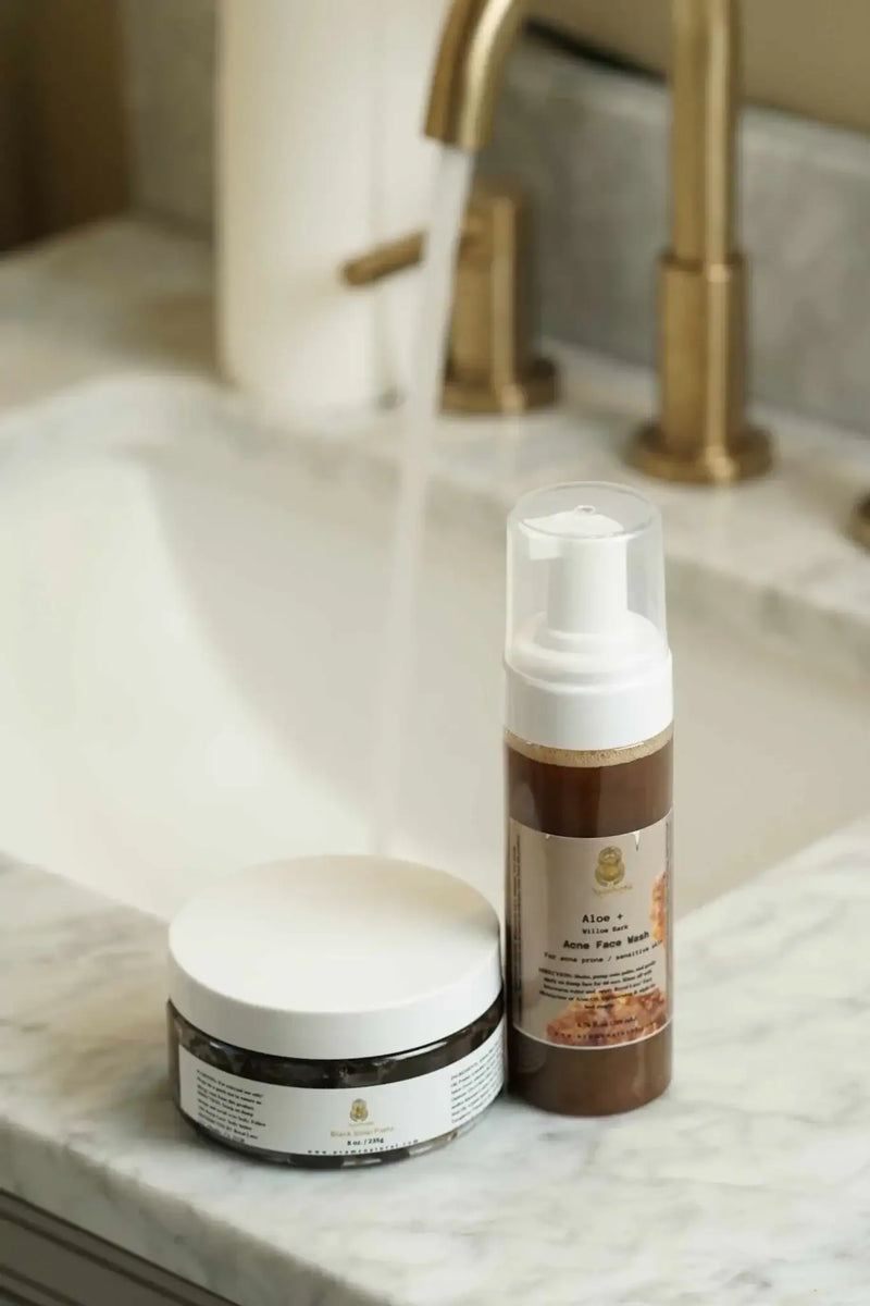 Natural Face Acne Wash& Black African Paste for sensitive & Oily Skin displayed on a marble sink for effective skincare.