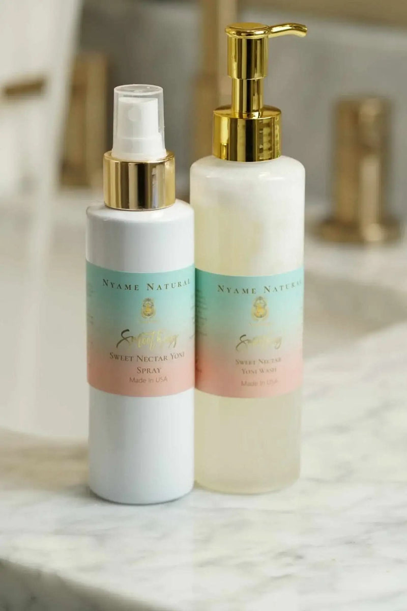RoyalLuxsLLC herbal yoni kit with two white bottles featuring gold pumps on a marble surface