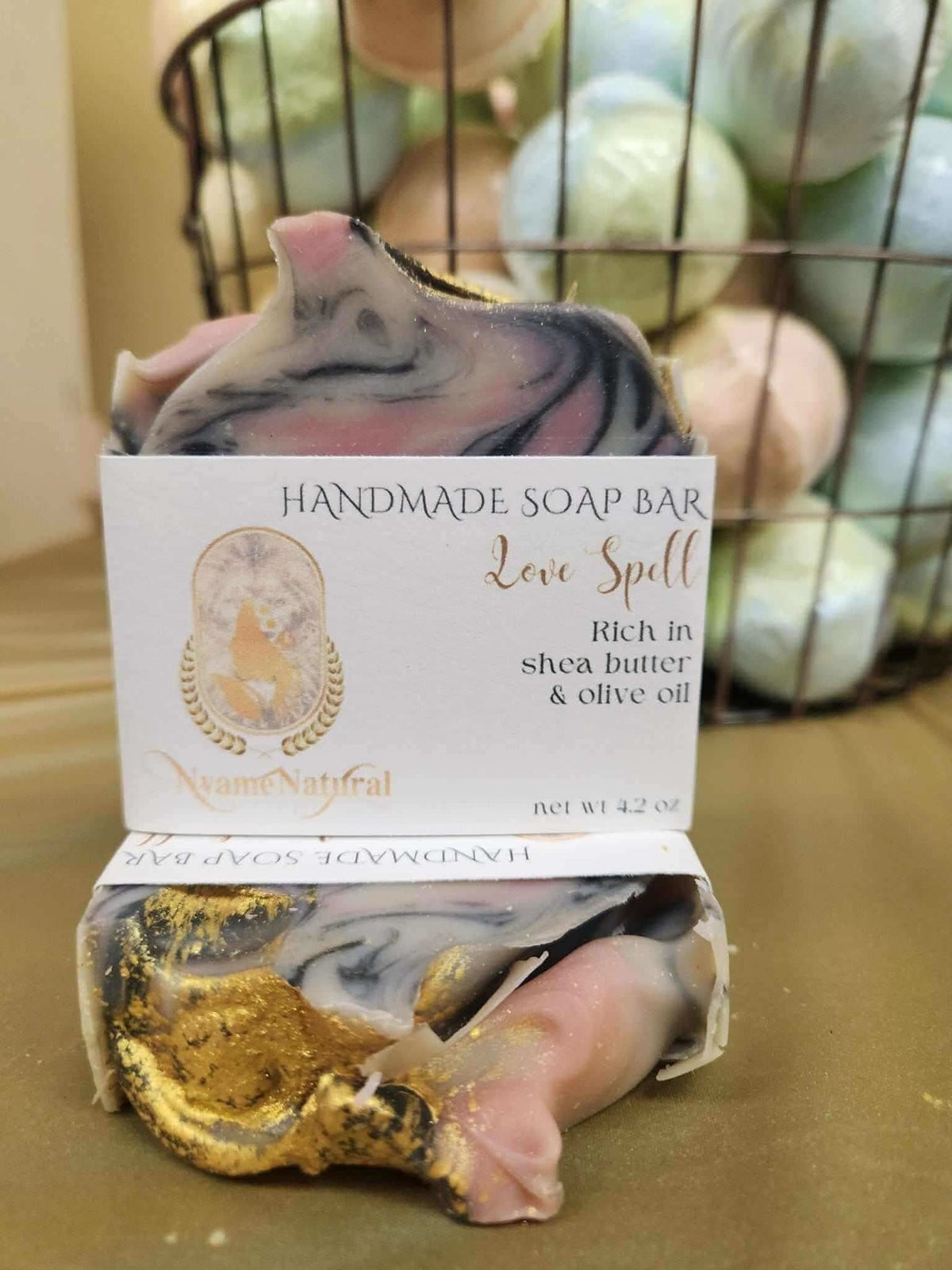 RoyalLuxsLLC love spell handmade soap bar with shea butter and olive oil in swirled pink black and gold colors