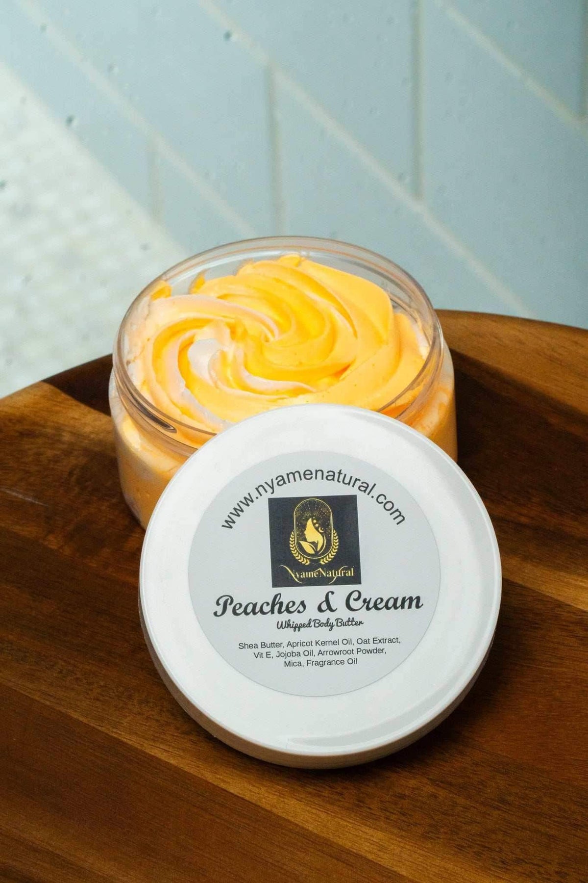 Peaches & Cream Body Butter in a jar, offering luxurious hydration and a delightful scent of peaches and vanilla cream.