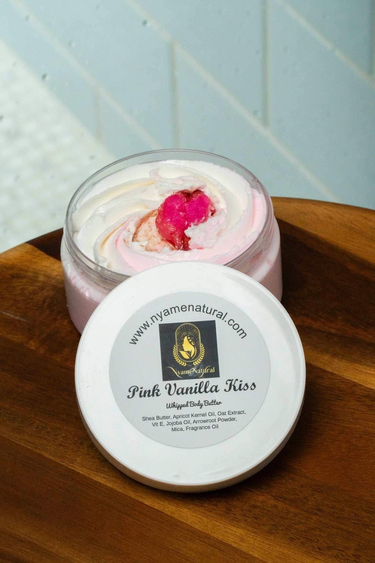 Pink Vanilla Kiss body butter in a jar, featuring a silky texture and a pink swirl, ideal for a non-sticky moisturizer.