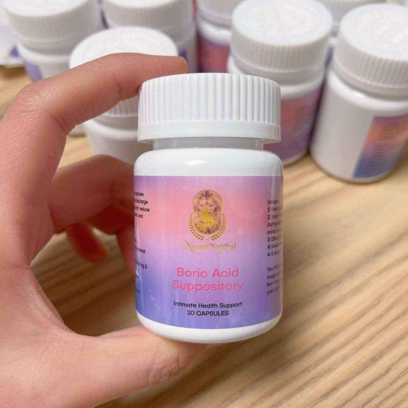 Pure Boric Acid suppository bottle in hand for intimate health support, 30 capsules for detox and cleanse.