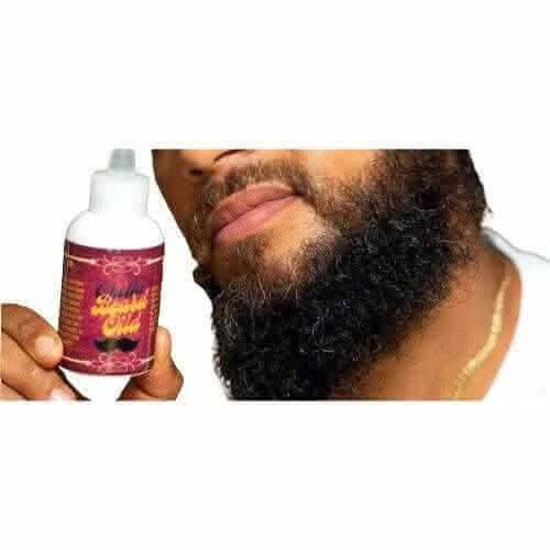 RoyalLuxsLLC natural beard oil for men held next to a well-groomed full beard