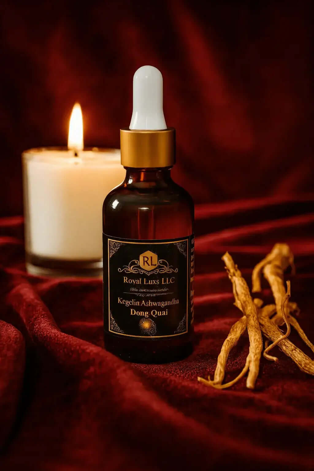RoyalLuxsLLC Kigelia Ashwagandha Dong Quai drops bottle with dropper on red fabric near lit candle and dried roots