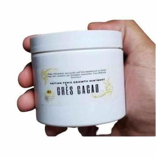 Hand holding RoyalLuxsLLC container of authentic Haitian gres cacao growth ointment cream