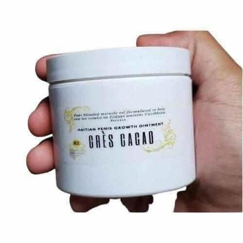 Hand holding RoyalLuxsLLC Haitian Gres Cacao hair growth ointment in a white container