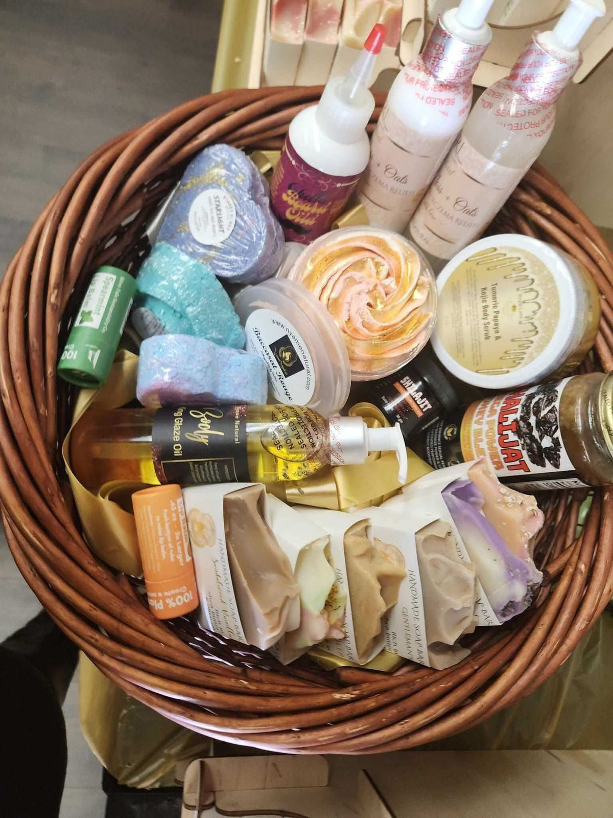 Relaxation gift basket for men with assorted bath bombs, body lotions, soap bars, and essential oils in a woven basket